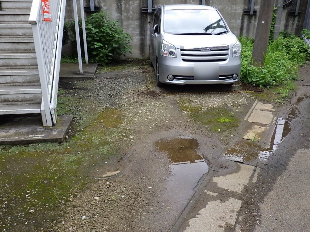 砂利敷きの駐車場にできた水たまり